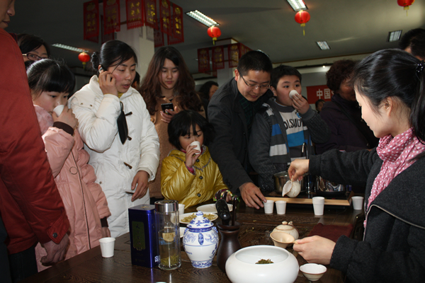 眾多游人駐足天方展位前品霧里青、嘗茶食品、觀茶藝表演